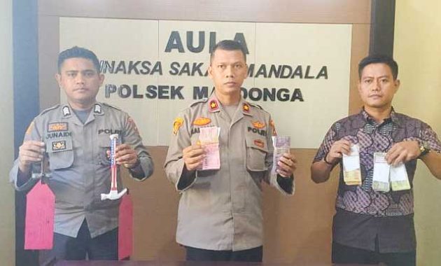 Kapolsek Mandonga, Kompol Muhammad Salman (tengah) didampingi Kanit Reskrim Polsek Mandonga, Aipda Andry (pertama dari kanan) saat memperlihatkan uang kotak amal Masjid Alkautsar Kendari yang dicuri pelaku, Jumat (3/6/2022). Foto/ist