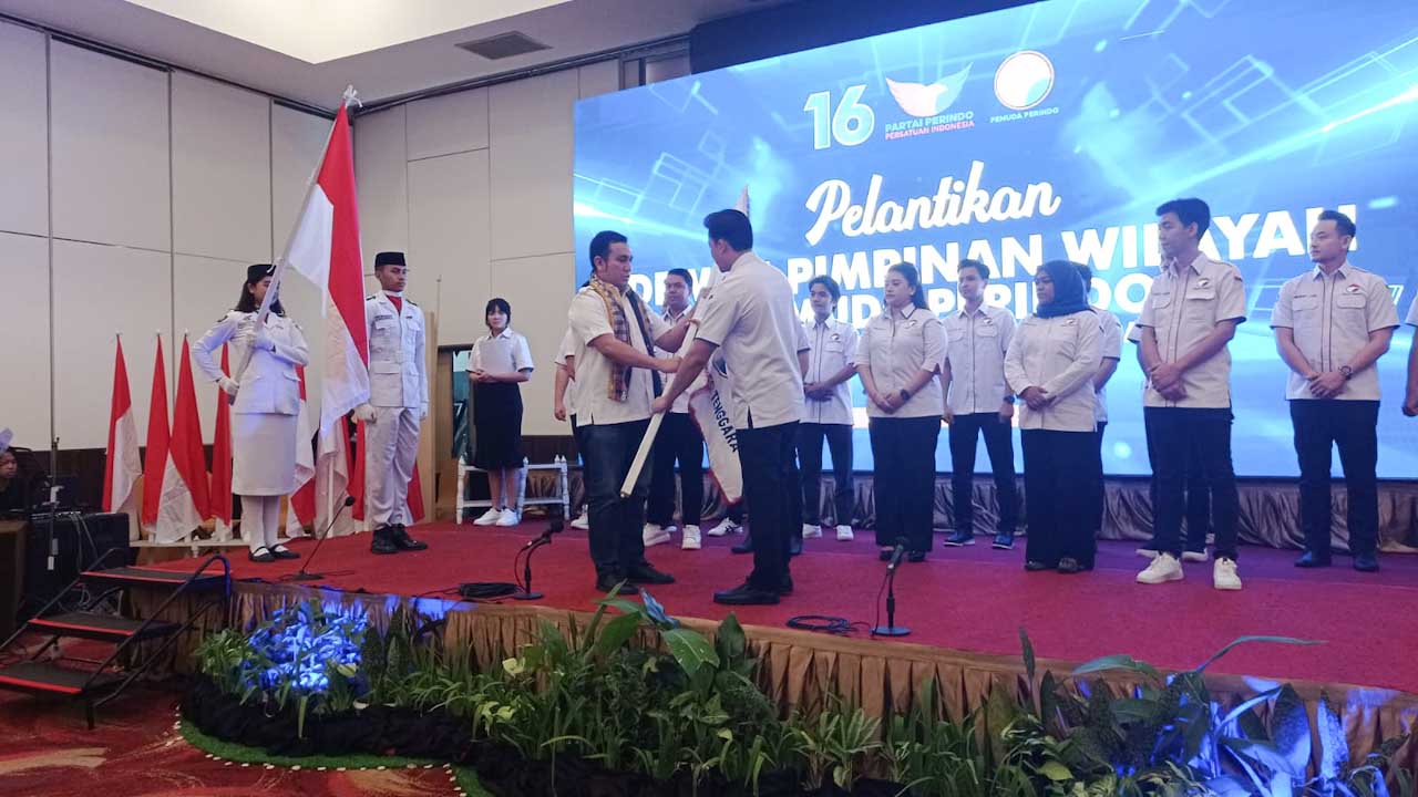 Ketua Umum DPP Pemuda Perindo, Effendy Syahputra (kiri) menyerahkan bendera Partai Perindo kepada youtuber Steven Stenly setelah resmi dilantik sebagai Ketua Dewan Pimpinan Wilayah (DPW) Pemuda Perindo Sulawesi Tenggara (Sultra) di salah satu hotel di Kendari, Selasa (28/2/2023). Foto/ist