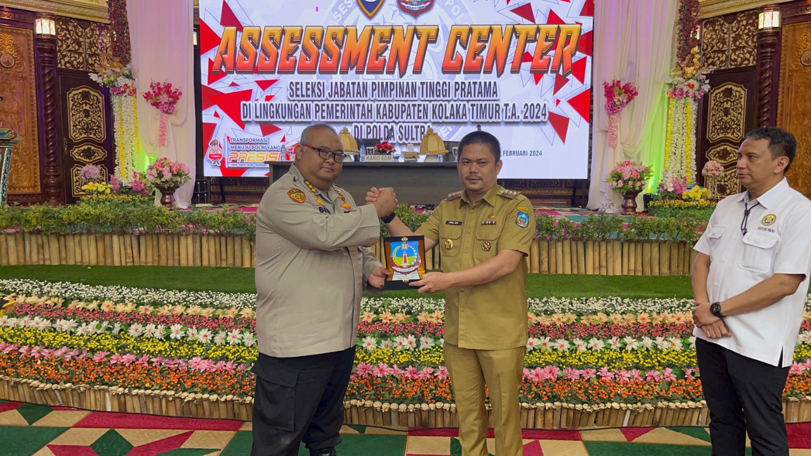 Bupati Kolaka Timur, Abdul Azis menyerahkan plakat dengan logo Kabupaten Kolaka Timur kepada Karo SDM Polda Sultra, Kombes Pol Danang Beny Kuspriandono saat pembukaan assessment center seleksi jabatan tinggi di kabupaten itu yang dilaksanakan di salah satu hotel di Kota Kendari, Selasa (20/2/2024). Foto/Dokumen Bidhumas Polda Sultra