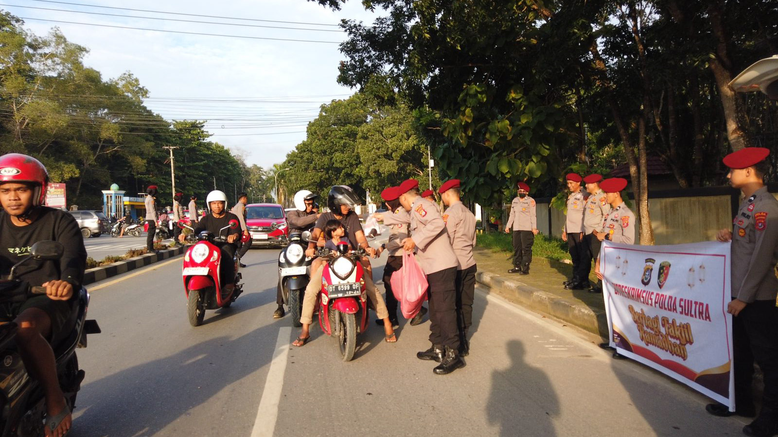 Personel Direktorat Reserse Kriminal Khusus (Ditreskrimsus) dan Bidang Teknologi Informasi dan Komunikasi (Bid TIK) Polda Sulawesi Tenggara (Sultra) bersama-sama melaksanakan kegiatan pembagian takjil buka puasa kepada masyarakat yang melintas di simpang empat depan Kantor Badan Pusat Statistik (BPS) Sultra, Jumat (22/3/2024). Foto/Bidhumas Polda Sultra